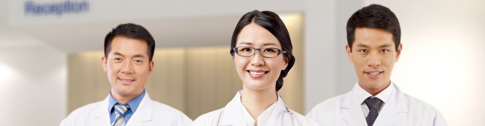 Three asian doctors standing in a row